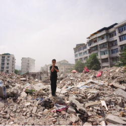 man with mobile phone after earthquake in Sichuan, China